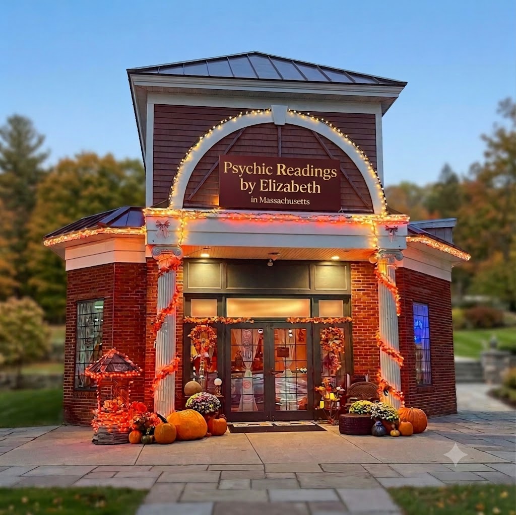 Psychic Readings by Elizabeth studio front at dusk in Pittsfield, Massachusetts — brick facade with lit archway sign and autumn pumpkins